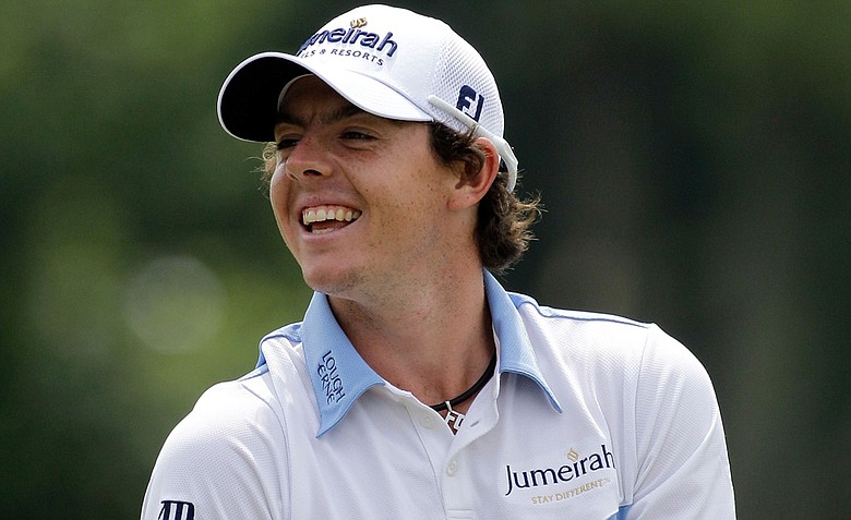 Rory McIlroy smiles as he waits to hit a shot on the practice range prior to the third round of the 111th U.S. Open.