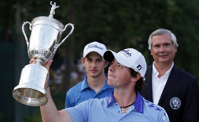 Rory McIlroy of Northern Ireland poses with the trophy after his eight-stroke victory on the 18th green during the 111th U.S. Open at Congressional Country Club on June 19, 2011 in Bethesda, Maryland.