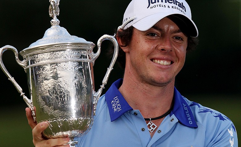 Rory McIlroy of Northern Ireland poses with the trophy after his eight-stroke victory on the 18th green during the 111th U.S. Open at Congressional Country Club on June 19, 2011 in Bethesda, Maryland.