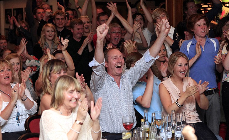 Members of Holywood golf club in Northern Ireland react early Monday, June 19, 2011 after watching Rory McIlroy win the U.S. Open Golf Championship on TV.