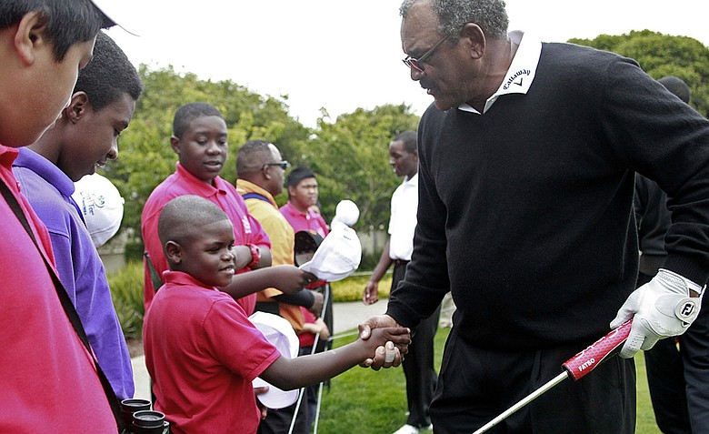 Rafiq Griffin, center, of First Tee San Francisco, shakes hands with Jim Thorpe during the Champions Tour's Nature Valley First Tee Open.