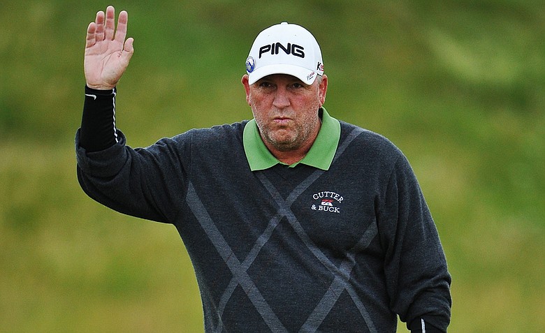 Mark Calcavecchia waves to the crowd during the first round of the 2011 Open Championship