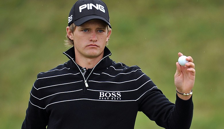 Amateur Tom Lewis of England acknowledges the crowd on the sixth hole during the first round of The 140th Open Championship at Royal St George's.