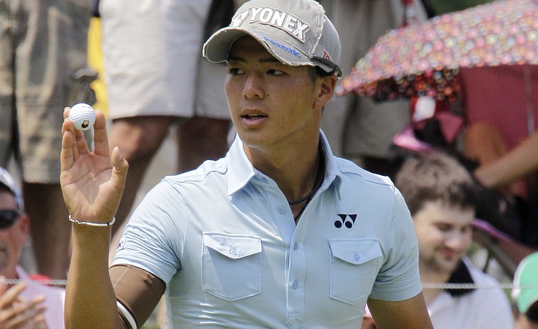 Ryo Ishikawa, from Japan, waves to the crowd after making birdie on the 17th hole during the third round of the Bridgestone Invitational golf tournament at Firestone Country Club in Akron, Ohio Saturday, Aug. 6, 2011. Ishikawa finished at 11-under par.