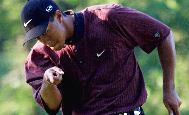 Tiger Woods points to his ball as it drops for birdie on the first hole of a three-hole playoff against Bob May at the PGA Championship, Sunday, Aug. 20, 2000, at the Valhalla Golf Club in Louisville, Ky. Woods would win the tournament to capture his second PGA Championship.