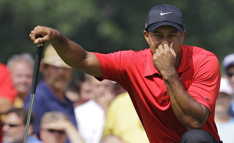 Tiger Woods looks over an eagle putt on the second hole during the final round of the Bridgestone Invitational golf tournament at Firestone Country Club in Akron, Ohio, Sunday, Aug. 7, 2011.