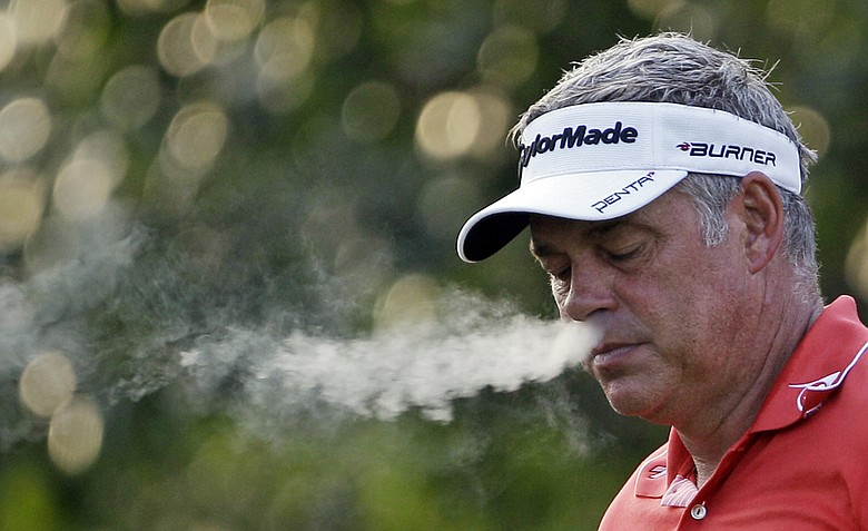 Darren Clarke, of Northern Ireland, smokes on the fifth hole during a practice round for the PGA Championship golf tournament Tuesday, Aug. 9, 2011, at the Atlanta Athletic Club in Johns Creek, Ga.