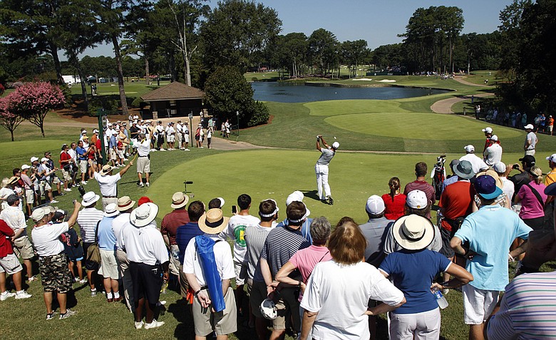 Adam Scott, of Australia, hits a shot on the fourth during a practice round for the PGA Championship golf tournament Wednesday, Aug. 10, 2011, at the Atlanta Athletic Club in Johns Creek, Ga.