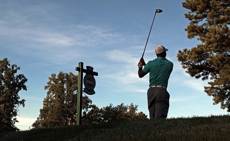 Tiger Woods hits a drive on the 14th hole during a practice round for the PGA Championship golf tournament Wednesday, Aug. 10, 2011, at the Atlanta Athletic Club in Johns Creek, Ga.