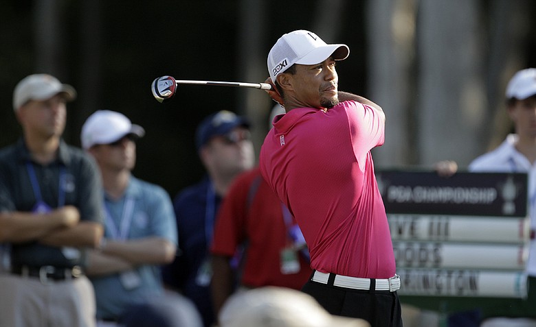 Tiger Woods hits a shot on the 11th hole during the first round of the PGA Championship golf tournament Thursday, Aug. 11, 2011, at the Atlanta Athletic Club in Johns Creek, Ga.