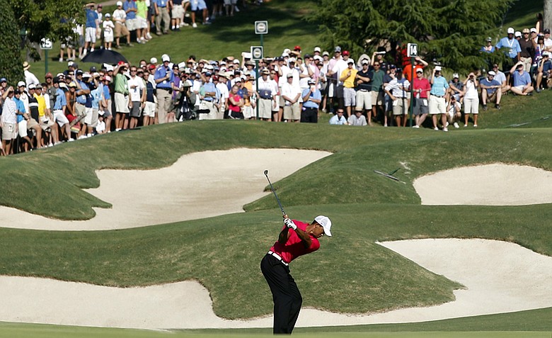 Tiger Woods hits up to the 14th green during the first round of the PGA Championship golf tournament Thursday, Aug. 11, 2011, at the Atlanta Athletic Club in Johns Creek, Ga.