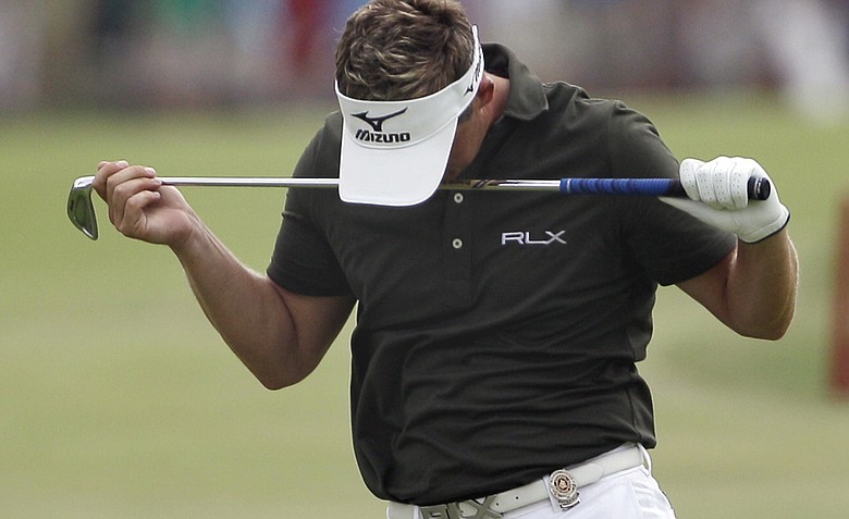 Luke Donald, of England, reacts after hitting into the water on the 18th hole during the third round of the PGA Championship golf tournament Saturday, Aug. 13, 2011, at the Atlanta Athletic Club in Johns Creek, Ga.