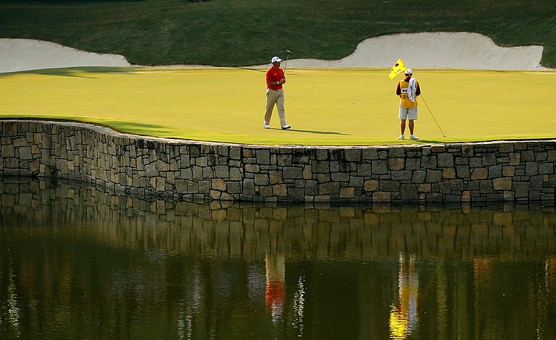 Lee Westwood of England and his caddie Billy Foster are seen on the 17th hole during the third round of the 93rd PGA Championship at the Atlanta Athletic Club on August 13, 2011 in Johns Creek, Georgia.