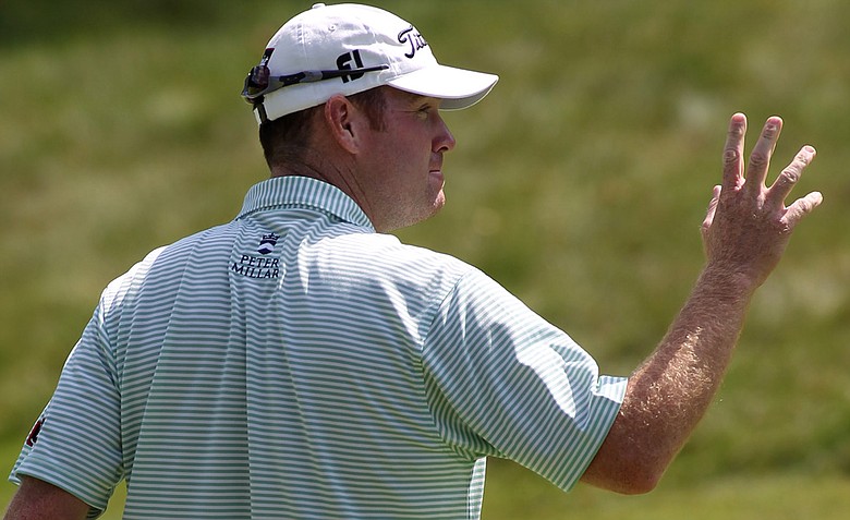 Troy Matteson waves to the gallery after making a birdie putt on the ninth hole during the first round of the Deutsche Bank Championship golf tournament at TPC Boston, Friday, Sept. 2, 2011, in Norton, Mass.