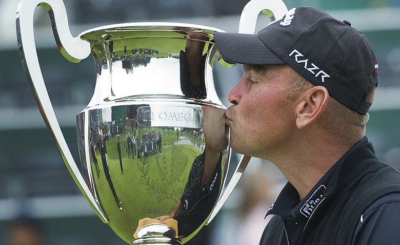 Thomas Bjorn from Denmark kisses the trophy after winning the Omega European Masters Golf Tournament in Crans Montana, Switzerland, Sunday, Sept. 4, 2011.
