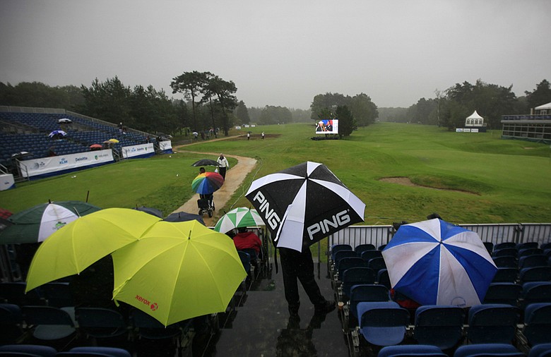 Spectators wait out a rain delay during the opening round of the KLM Open.