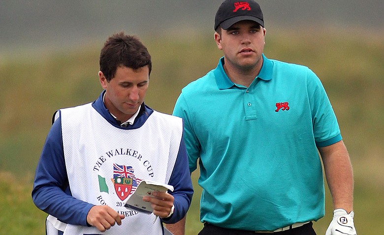 Jack Senior of Great Britain and Ireland with his caddy, Joe Senior, during the day one morning foursomes matches of the 2011 Walker Cup held on the Balgownie Links at Royal Aberdeen Golf Club on September 10, 2011 in Aberdeen, Scotland. Joe Senior is no longer on his brother's bag after his professional golf status was brought to light, a rule violation. Jack Senior and partner Andy Sullivan won their match, and the victory was upheld because the rule violation was not revealed until after the victory was declared.