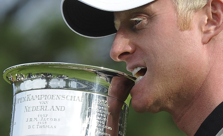 Simon Dyson of Britain poses with the trophy after winning the KLM Open Golf tournament in Hilversum, western Netherlands, Sunday, Sept. 11, 2011.