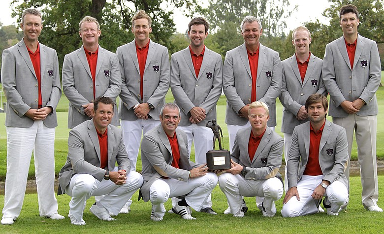 Captain of Great Britain and Ireland, Paul McGinley (front second left), holds the trophy as he poses with the team after winning the Vivendi Seve Trophy against the Continental Europe team at Saint Nom La Breteche, west of Paris, on Sunday.
