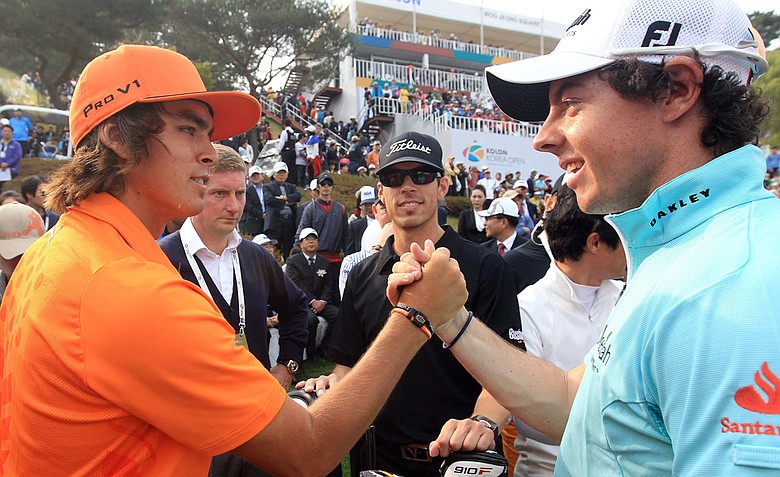 Rickie Fowler (left) receives congratulations from Rory McIlroy after winning the Korea Open. Fowler shot 16-under 268.