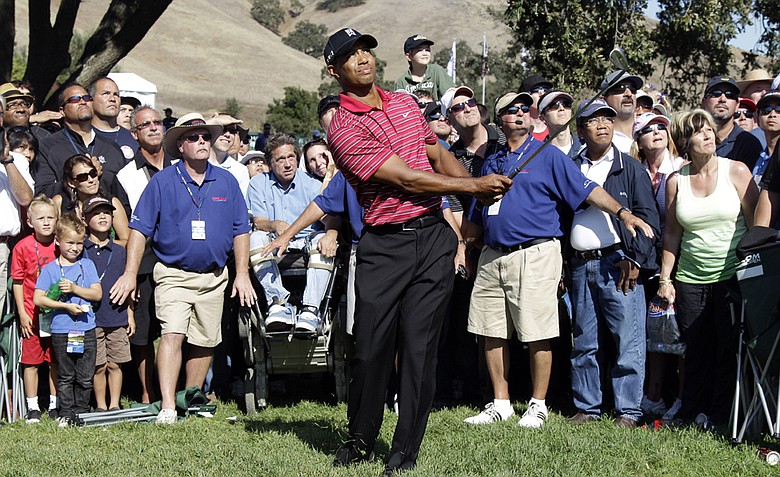 Tiger Woods chips to the green on the ninth hole during the final round of the Frys.com Open.