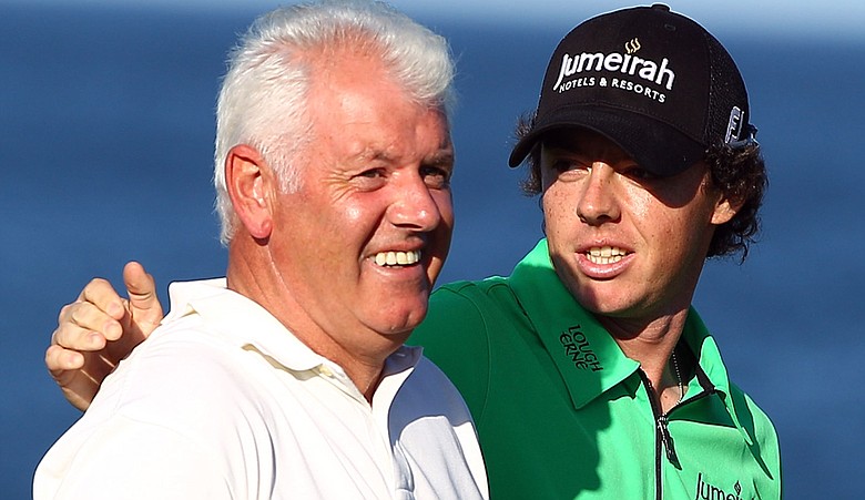 Rory McIlroy congratulates his father Gerry after holing a putt on the seventh green during the first round of The Alfred Dunhill Links Championship at the Kingsbarns Golf Links.