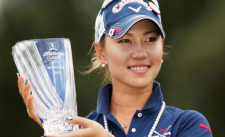 Momoko Ueda of Japan celebrates her victory with the trophy after the 3rd playoff hole in the final round of the Mizuno Classic.