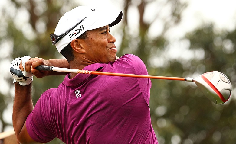 Tiger Woods tees off on the third hole during the first day of the 2011 Australian Open.