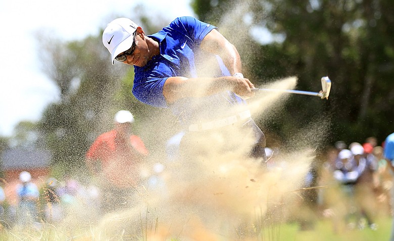 Tiger Woods hits his second shot from the waste sand on the third hole during day three of the 2011 Australian Open.