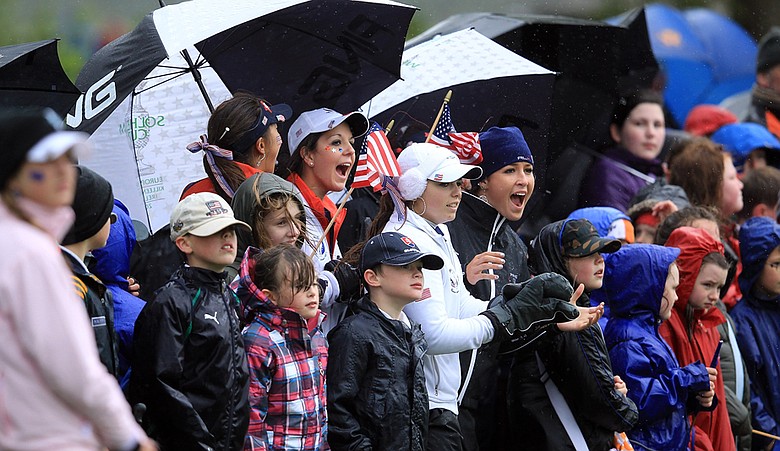 Members of the U.S. Junior Solheim Cup team cheer on teammates alongside local children at Knightsbrook Golf Resort and Spa.