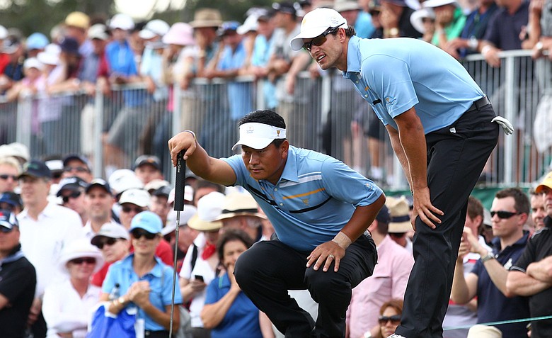 International team duo K.J. Choi and Adam Scott look at a putt on the 12th hole during the Day 1 Foursome matches.