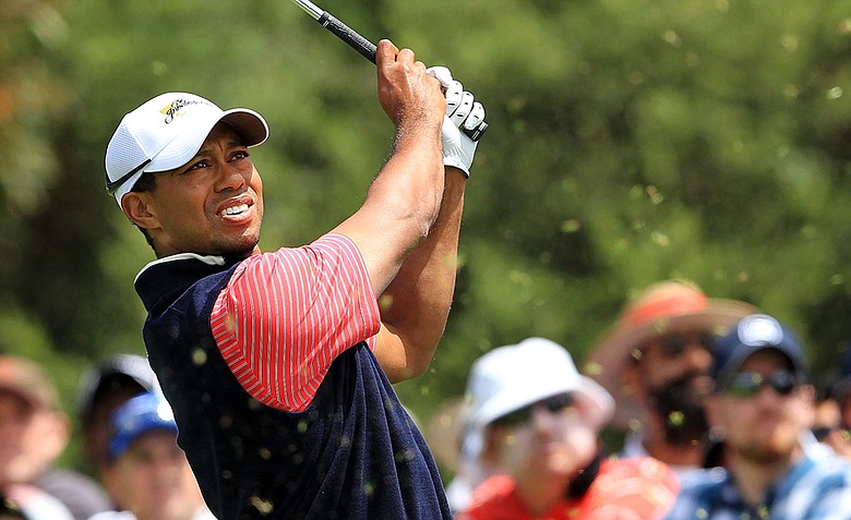 Tiger Woods of the U.S. hits his tee shot on the third hole during the Day Four singles matches of the 2011 Presidents Cup.