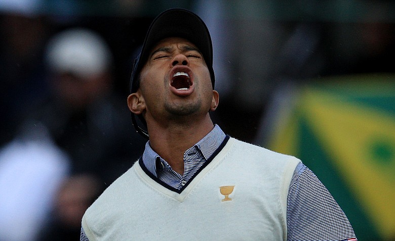 Tiger Woods of the U.S. reacts to a missed putt on the 14th hole during the Day 3 afternoon four-ball matches of the 2011 Presidents Cup.