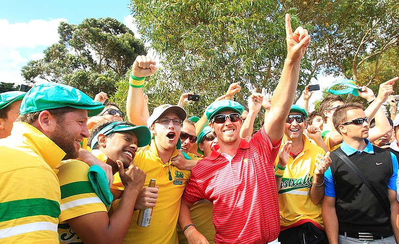 Hunter Mahan of the U.S. celebrates with Aussie fans on the 17th hole after the Day Four singles matches of the 2011 Presidents Cup.