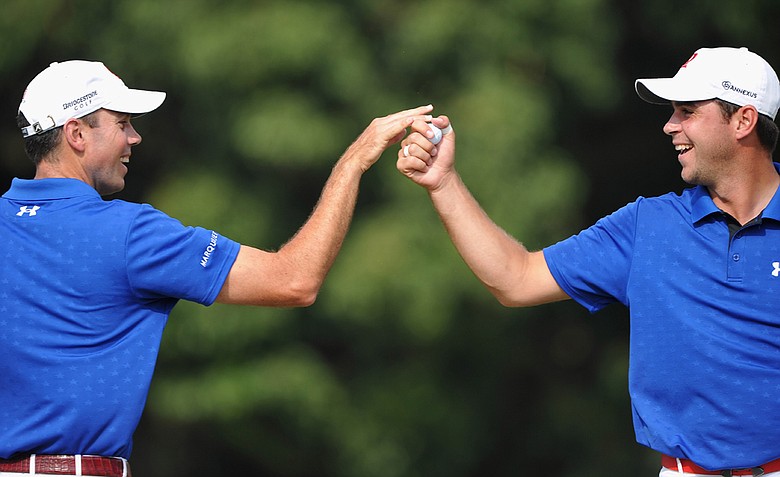 Gary Woodland celebrates his putt on the 13th hole with playing partner Matt Kuchar during Day 4 foursomes at the Omega Mission Hills World Cup.
