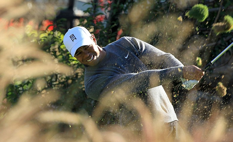 Tiger Woods hits his tee shot on the 12th hole during the third round of the Chevron World Challenge.