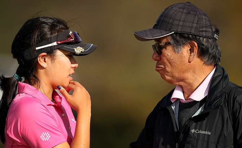 Stephanie Kono of UCLA talks with dad, Teruo Kono, while deciding whether to turn pro after finishing in the top 20 during the final round of LPGA Qualifying Tournament at LPGA International.
