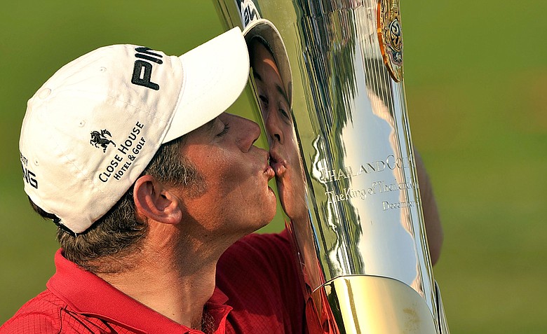 Lee Westwood kissing the winner's trophy after the final round at the Thailand Golf Champioship.