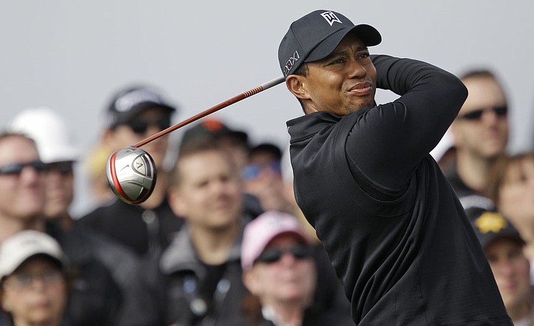 Tiger Woods fired a 5-under 67 on Saturday and is four shots behind Charlie Wi heading into the final round.