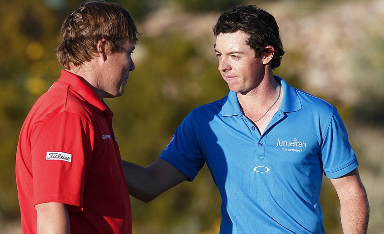 Rory McIlroy, right, greets George Coetzee after McIlroy won their first-round match, 2 up.