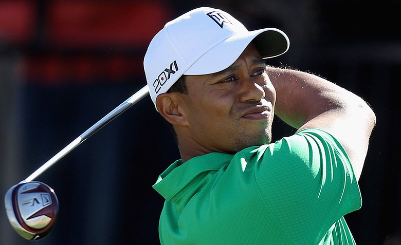 Tiger Woods hits his tee shot on the first hole during the first round of the World Golf Championships-Accenture Match Play Championship.