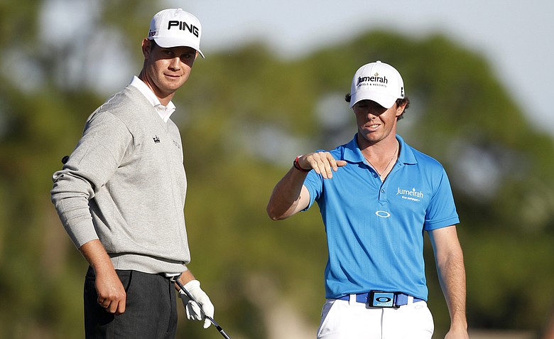 Rory McIlroy of Northern Ireland, right, talks with Harris English, left, during the final round of the Honda Classic.