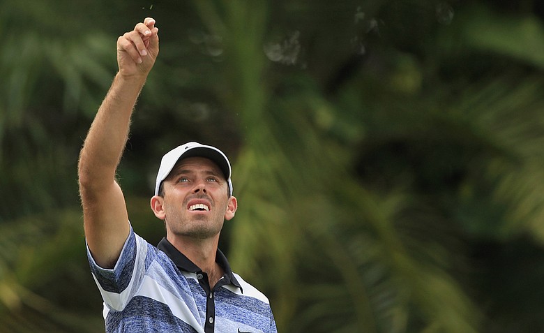 Charl Schwartzel tests the wind on the 15th hole during first round of the WGC-Cadillac Championship.