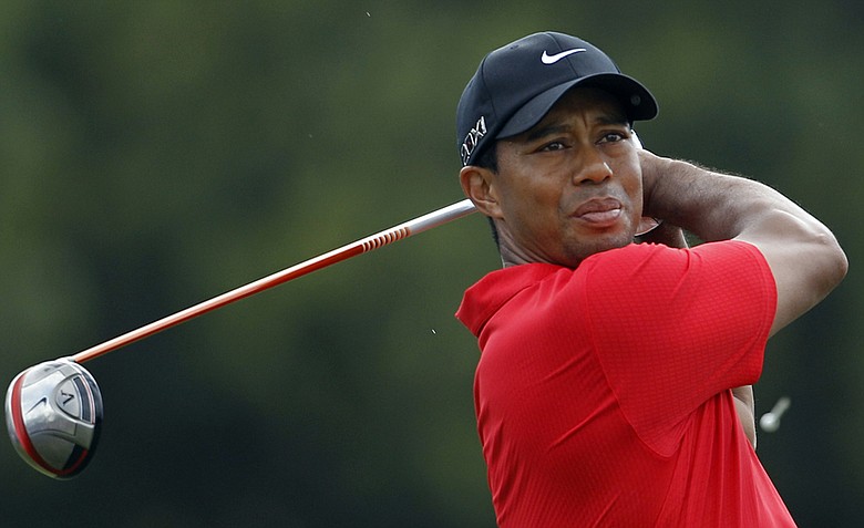 Tiger Woods watches his shot from the third tee, during the final round of the Cadillac Championship.
