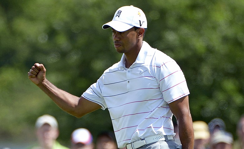 Tiger Woods pumps his fist after sinking a birdie putt on the sixth hole during the second round of the Arnold Palmer Invitational.