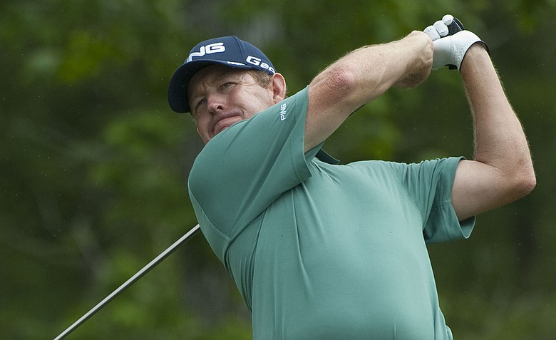 Jeff Maggert watches his tee shot on the 13th hole during the first round of the Houston Open.