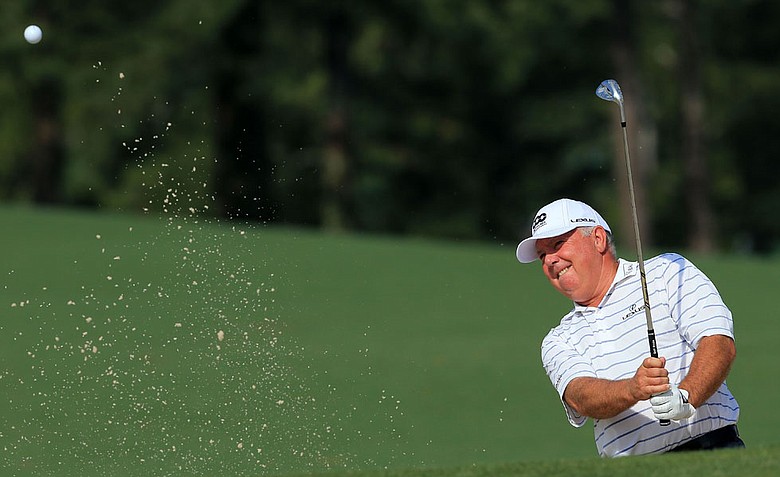 Mark O'Meara hits a shot out of the bunker during a practice round prior to the start of the 2012 Masters Tournament at Augusta National.