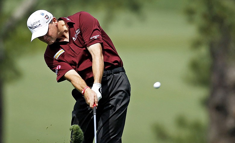 Paul Lawrie hits an iron shot during the first round of the Masters.