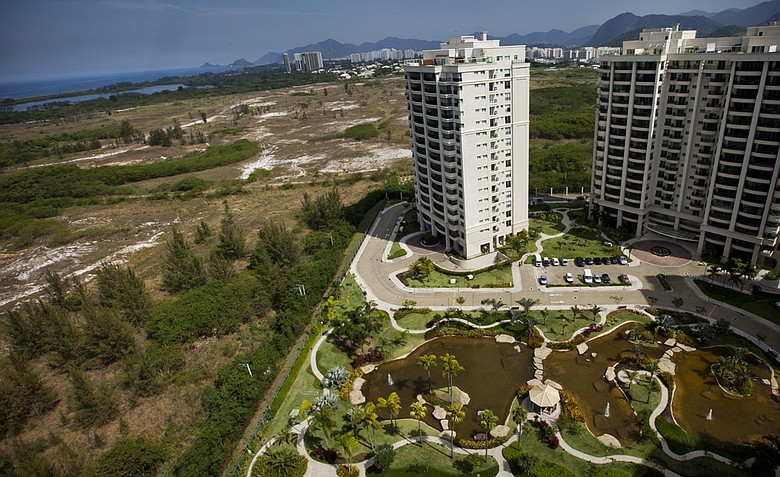 Luxury condominiums overlook the area, on left, where the Rio 2016 Olympic golf course is planned to be built in Rio de Janeiro's Barra da Tijuca neighborhood, Brazil. Rio 2016 organizers faced an unexpected challenge to deliver the first Olympic golf tournament in more than 100 years because of a legal dispute over the land where the historic course is supposed to be built.