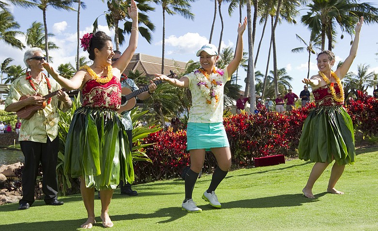 Ai Miyazato, center, dances the hula after winning the LPGA LOTTE Championship golf tournament at Ko Olina Golf Club.